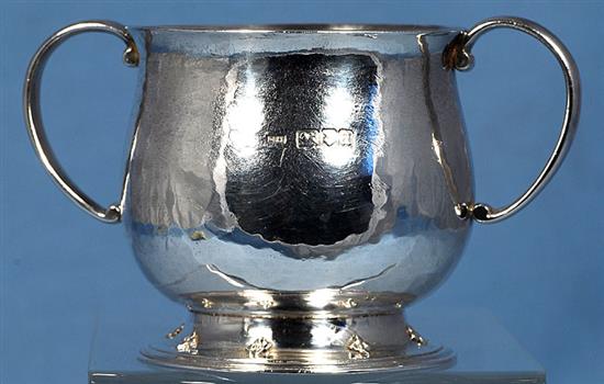 A George V Arts & Crafts silver two handled cup, Width to handles 5”/128mm Height 3”/78mm Weight 7oz/197grms